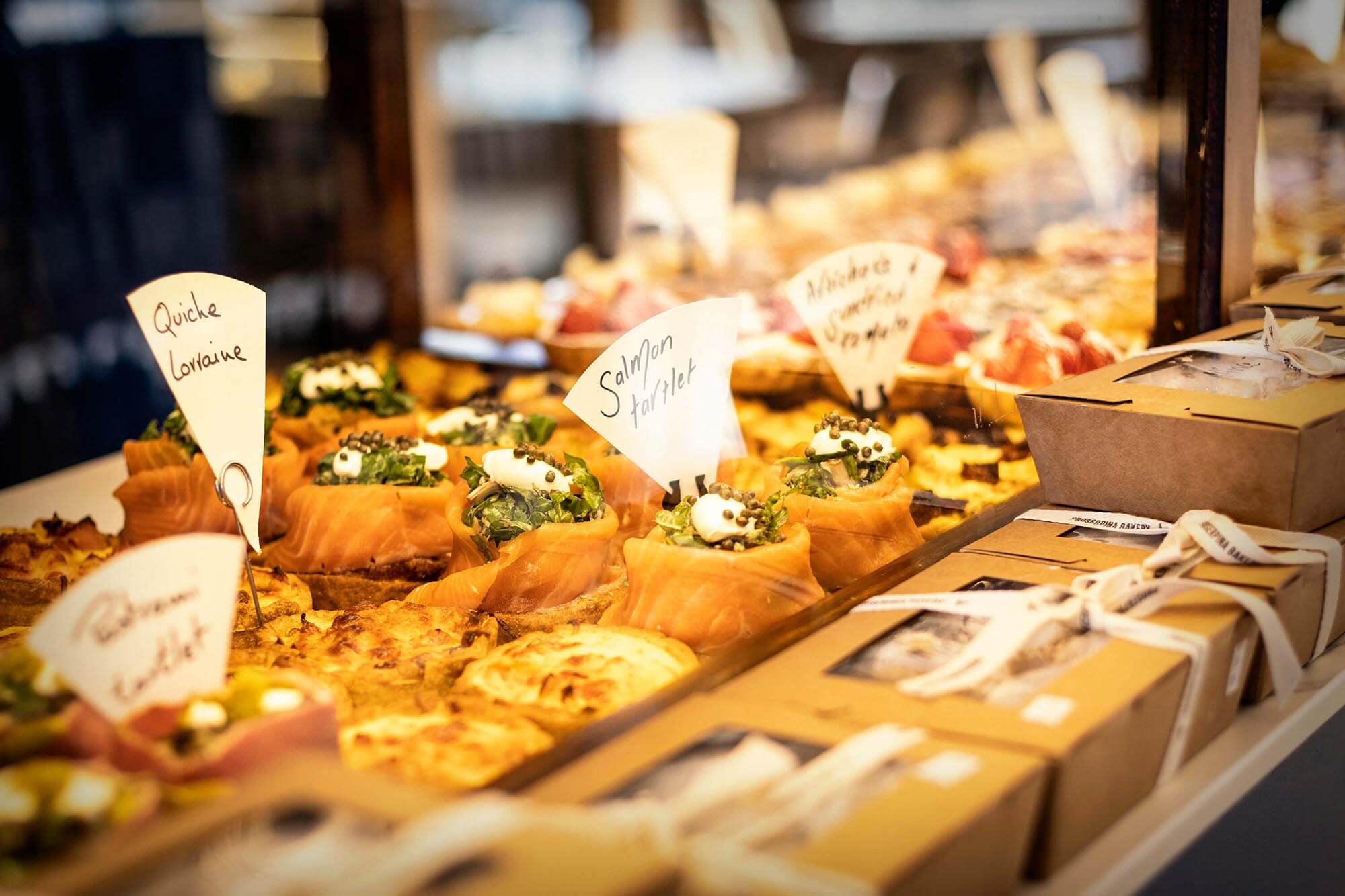 A selection of savoury tartlets and quiches in the display window